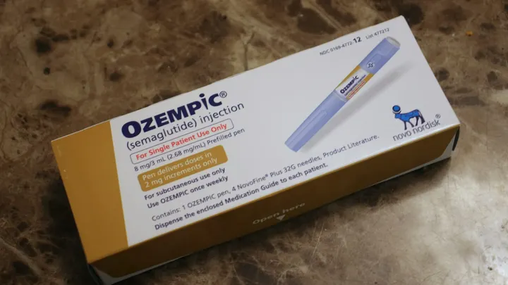 A box of Ozempic, a prescription semaglutide injection used for diabetes and weight management, shown on a brown surface.