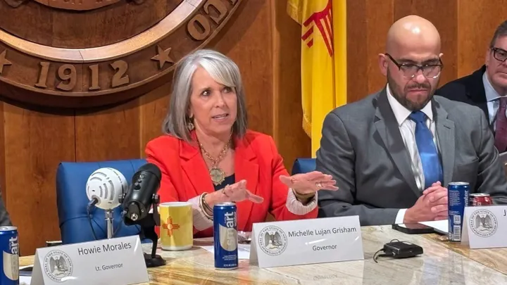 New Mexico Gov. Michelle Lujan Grisham speaks at a Roundhouse news conference after the legislative session, seated beside House Speaker Javier Martínez.