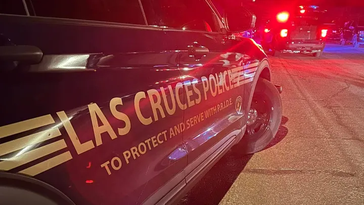 Las Cruces Police Department patrol vehicles with emergency lights activated at night.