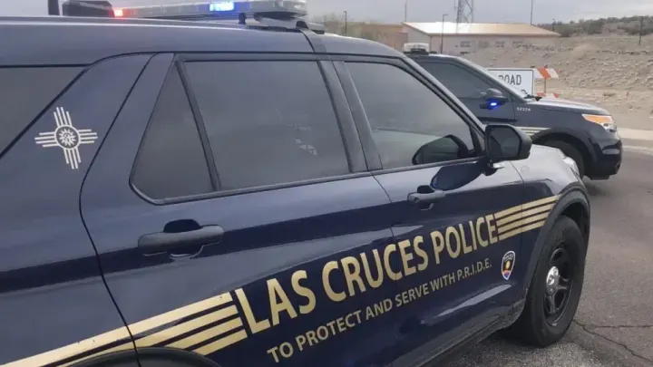 Las Cruces police vehicles with emergency lights parked during a response.