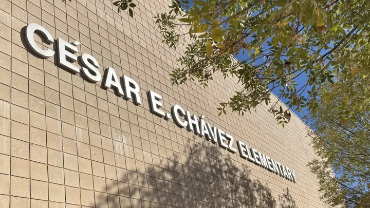 Exterior of Cesar Chavez Elementary School building in Las Cruces with name displayed on brick wall