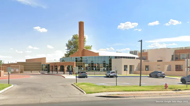Exterior view of the Third Judicial District Court building in Las Cruces, New Mexico, with a parking lot and entrance in front.