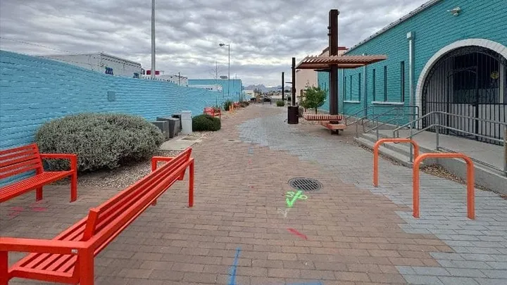 Pedestrian walkway in downtown Las Cruces Callecitas area with benches and buildings along the corridor