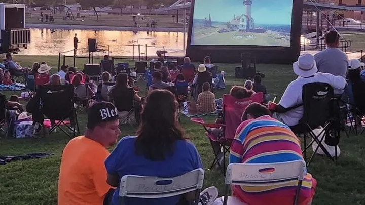 Families gather at Young Park in Las Cruces to watch an outdoor movie during the city’s Movies in the Park series