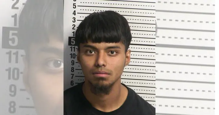 Front-facing booking photo of Tomas Rivas, a young man with short dark hair, standing against a height chart background.
