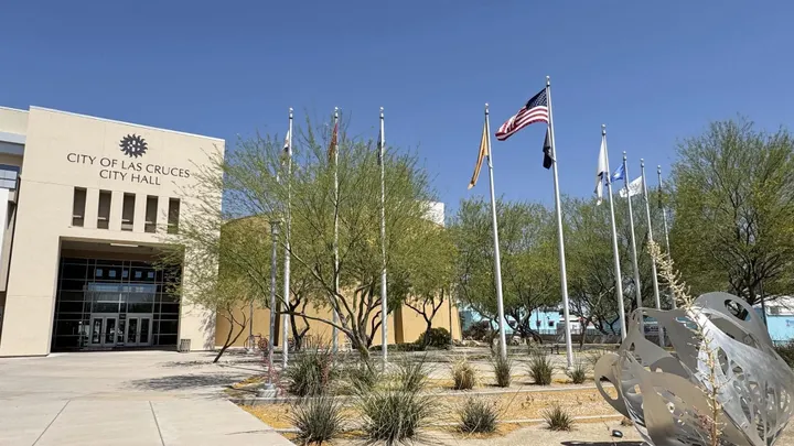 Exterior view of Las Cruces City Hall with flags displayed outside the building.