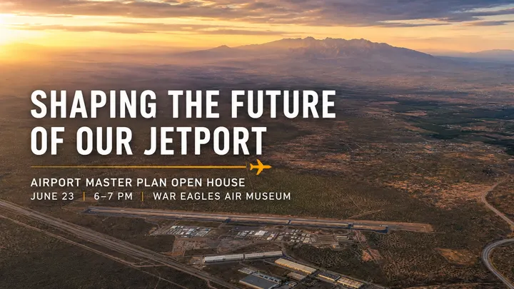Aerial view of the Doña Ana County International Jetport with desert landscape, mountains and airport infrastructure at sunset.