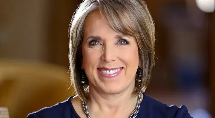 Gov. Michelle Lujan Grisham smiles in an official portrait photograph.