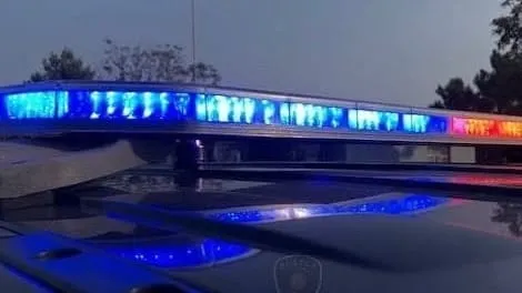 Close-up image of flashing blue and red police lights on top of a law enforcement vehicle.