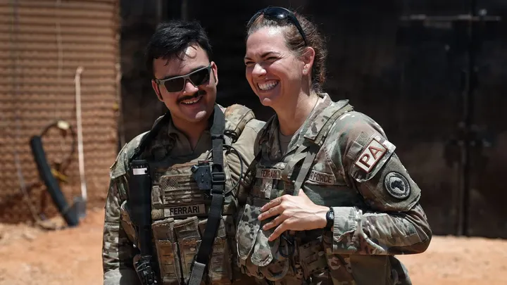 U.S. Air Force Senior Airman Michelle Ferrari smiles beside her son, U.S. Army Spc. Nicolas Ferrari, during a reunion while both were deployed in East Africa.