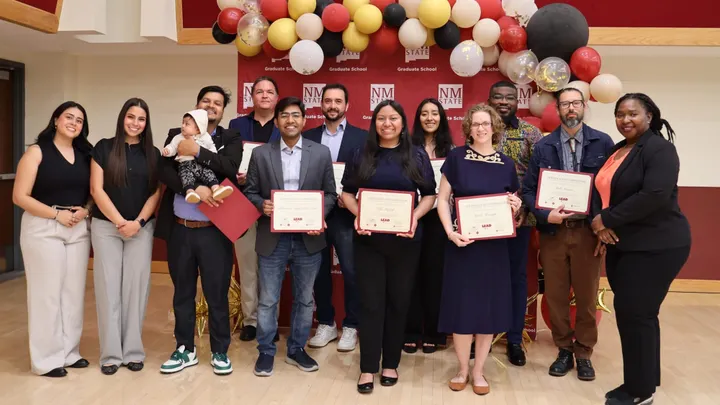 Graduates and program leaders pose with certificates during New Mexico State University’s inaugural LEAD cohort celebration at the spring graduation ceremony.