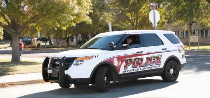 New Mexico State University police vehicle parked on a campus street