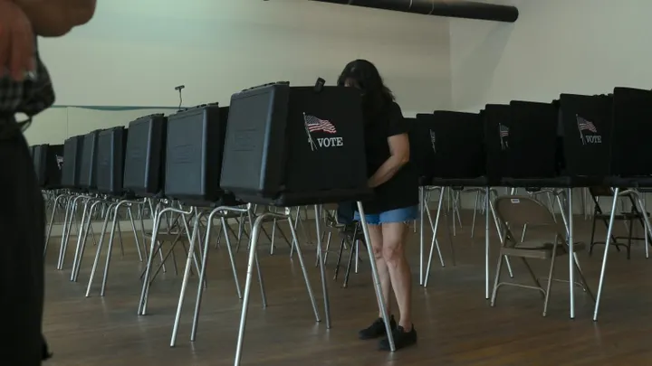 A voter stands at a voting booth inside an early voting location in New Mexico ahead of the June 2 primary election.