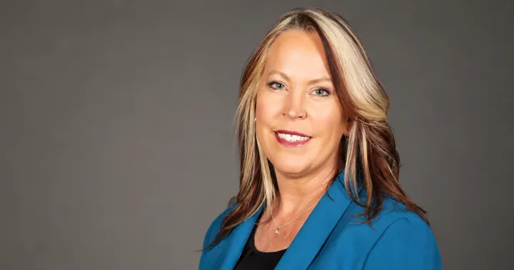 A campaign portrait shows Kimberly Skaggs wearing a blue blazer against a gray studio background.