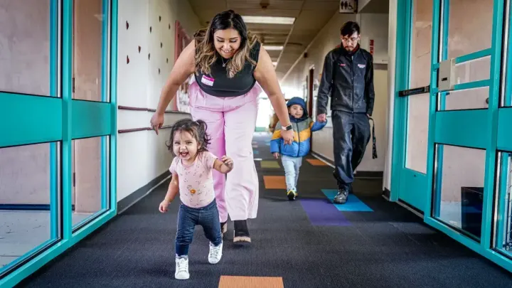 Vanessa Rodriguez chases her daughter, Eliana Gonzalez, down a hallway at Santa Fe Community College’s Kids Campus.