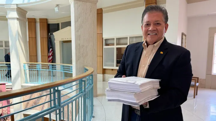 Ken Miyagishima carries a box of ballot petition signatures at the New Mexico Secretary of State’s Office in Santa Fe.