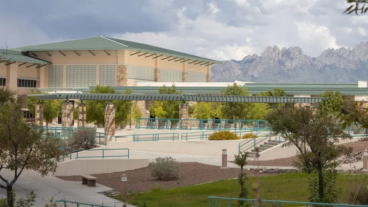 Buildings and walkways at Doña Ana Community College’s East Mesa campus with the Organ Mountains rising in the background.