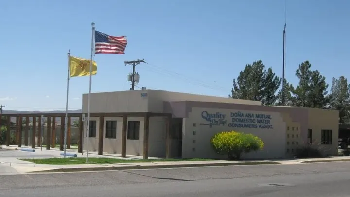The Doña Ana Mutual Domestic Water Consumers Association office with U.S. and New Mexico flags flying outside the building.