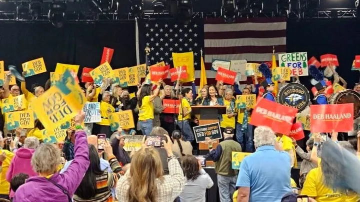 Supporters wave signs and cheer as Democratic gubernatorial nominee Deb Haaland speaks during the New Mexico Democratic Party's pre-primary convention in March 2026.