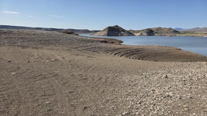 Dry, exposed shoreline stretches toward the remaining water at Elephant Butte Lake State Park on July 30.