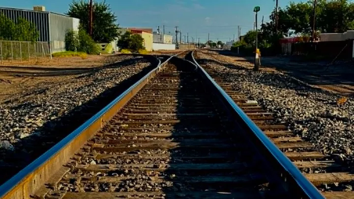 Multiple railroad tracks run through an industrial area in Las Cruces.