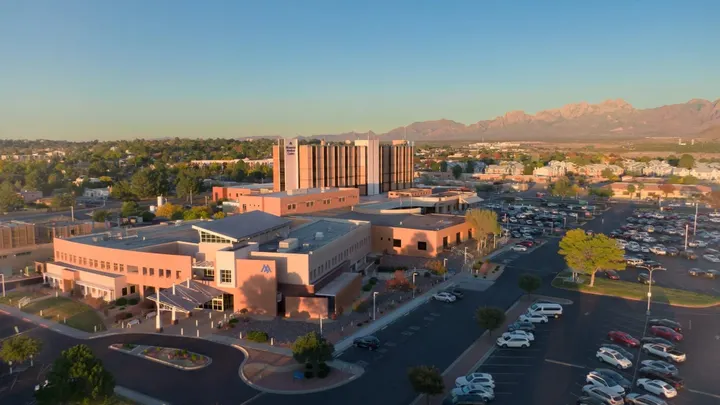 An aerial view shows Memorial Medical Center in Las Cruces with the Organ Mountains in the background.