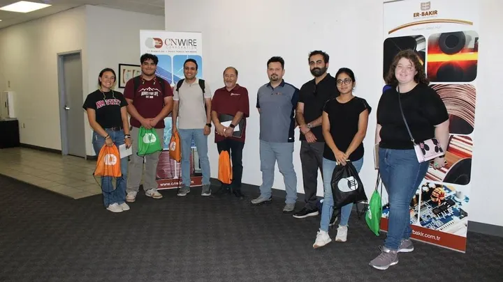 NMSU engineering students, a research scientist and a CN Wire manager stand together inside the company’s Santa Teresa manufacturing facility.