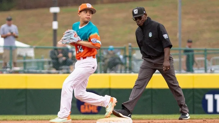 NMSU graduate Raymy Brown stands on a baseball field in his umpire uniform during the 2025 Little League Baseball World Series.