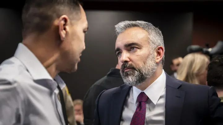 New Mexico Attorney General Raúl Torrez speaks with Simon Garcia after a news conference about the Justice Department’s investigation of CYFD.