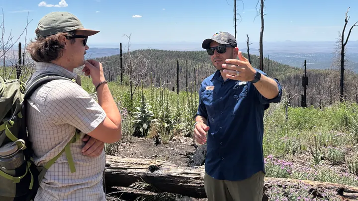 U.S. Rep. Gabe Vasquez gestures while speaking with a hiker in a burned area of the Gila National Forest on July 10, 2026.