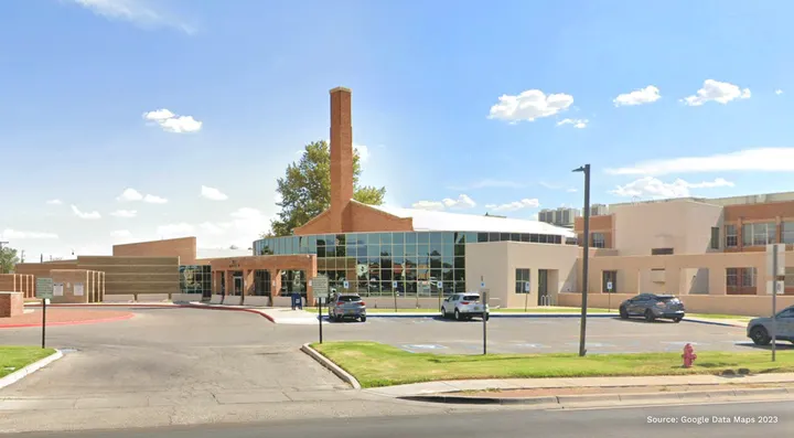 The Third Judicial District Courthouse in Las Cruces, shown from the street with its main entrance, parking area and surrounding grounds.
