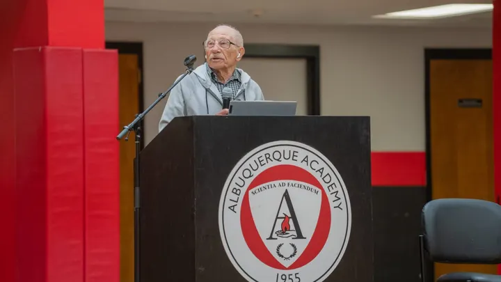 Holocaust survivor Andy Holten speaks at a podium during an event at Albuquerque Academy.