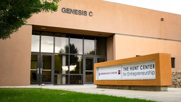 Exterior of the Genesis Center at New Mexico State University’s Arrowhead Center, with signage for the Hunt Center for Entrepreneurship near the entrance.
