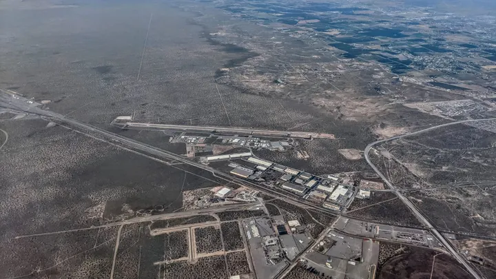 Aerial view of the Doña Ana County International Jetport, nearby industrial development and surrounding desert near Santa Teresa.