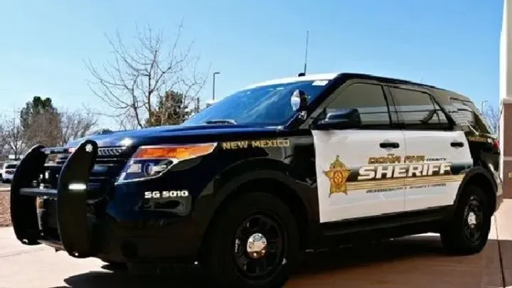 Doña Ana County Sheriff’s Office patrol SUV parked outside under a clear blue sky.