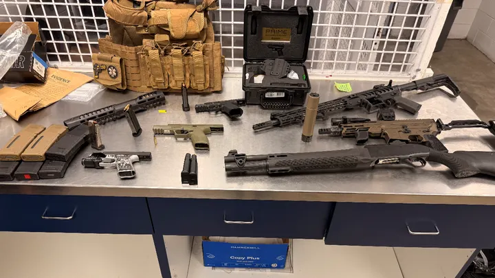 Firearms, firearm parts, magazines and body armor seized during a multi-agency gang investigation in Las Cruces.
