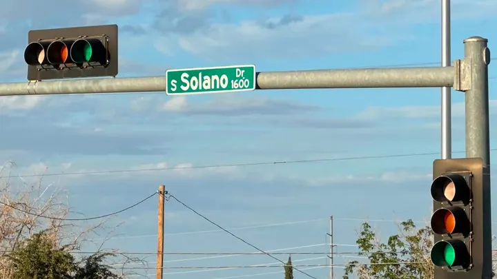 Traffic lights and a South Solano Drive street sign near Missouri Avenue in Las Cruces, where police say a father and son were injured in a drive-by shooting.