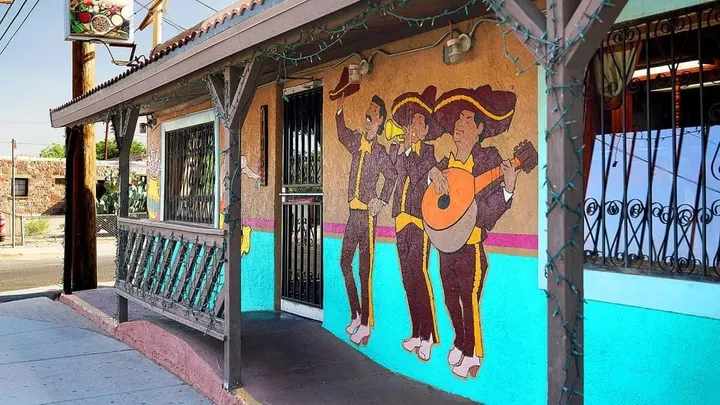 Exterior of La Nueva Casita Cafe on Mesquite Street in Las Cruces, featuring its colorful facade and mariachi mural.