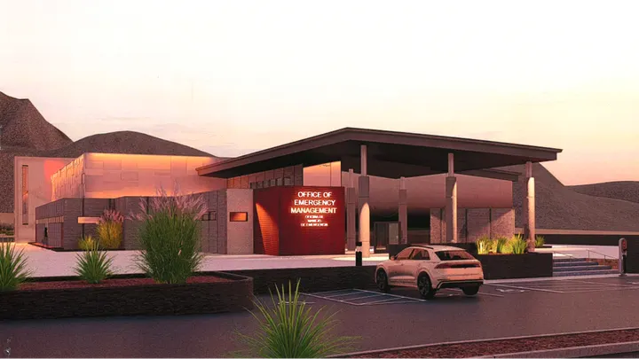 Rendering of the new Doña Ana County Office of Emergency Management facility, showing the building entrance, covered drive and desert landscaping.