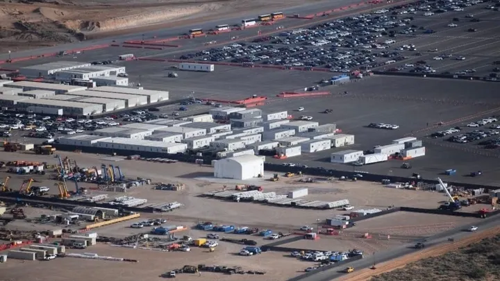 Aerial view of the Project Jupiter construction site in Santa Teresa, showing temporary buildings, equipment, parking areas and active construction.