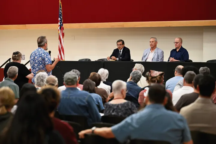 A Doña Ana County resident speaks during an Aug. 11 Project Jupiter listening session as state Sens. Joseph Cervantes, Bill Soules and Jeff Steinborn listen.