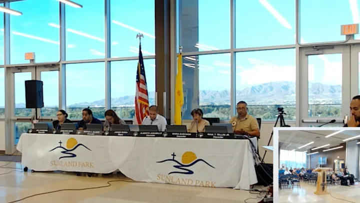 Sunland Park City Council members sit at a dais during the Aug. 18 meeting at the Multi-Generational Center, with mountains visible through windows.