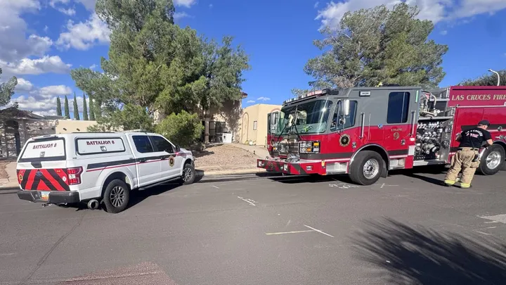 A Las Cruces Fire Department engine and battalion chief's pickup truck parked outside a home on Cadiz Court following a residential fire.