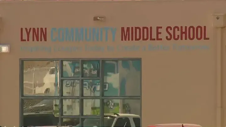 The exterior of Lynn Community Middle School in Las Cruces features the school's name in red and blue lettering above a large window.