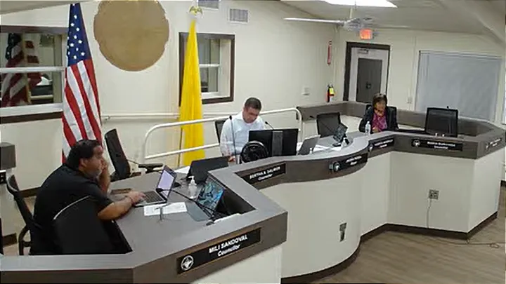Three Sunland Park city officials sit at the council dais during the Oct. 20 meeting, with American and New Mexico flags behind them.