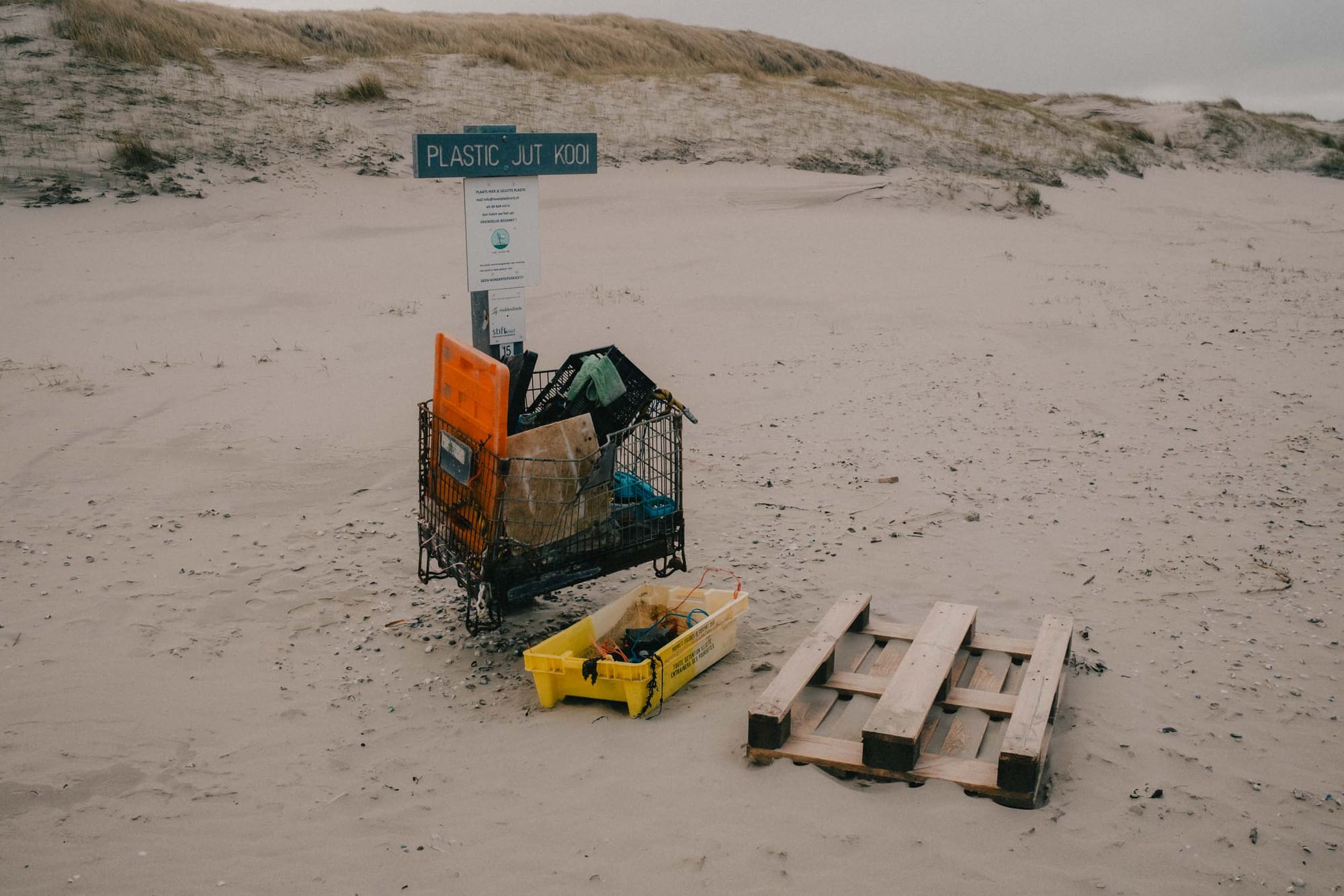 The beach is dotted with these trash-collection points. They call it a 'jutkooi' which is a beachcomber’s cage where visitors collect plastic and debris washed ashore, continuing a long-standing Dutch tradition of “jutten,” gathering what the sea leaves behind.