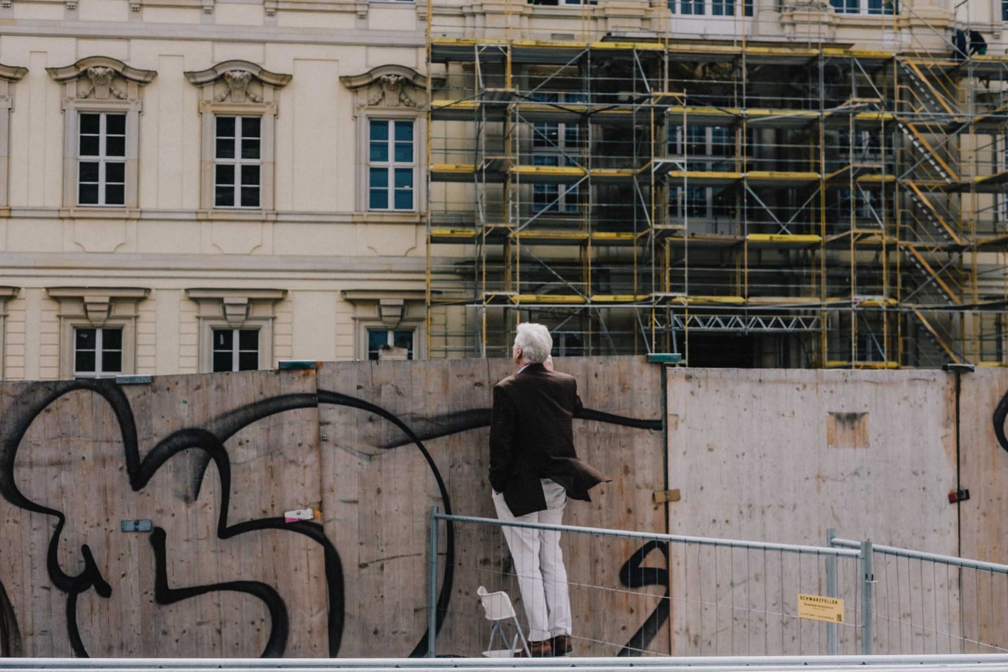 Man standing beside a construction site in Berlin photographed with the Fujifilm XF35mm f2