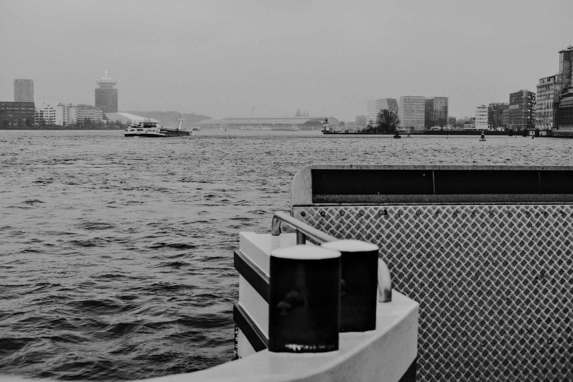 View across the IJ waterfront in Amsterdam photographed with the Fujifilm XF35mm f2 at f5 during an overcast ferry crossing