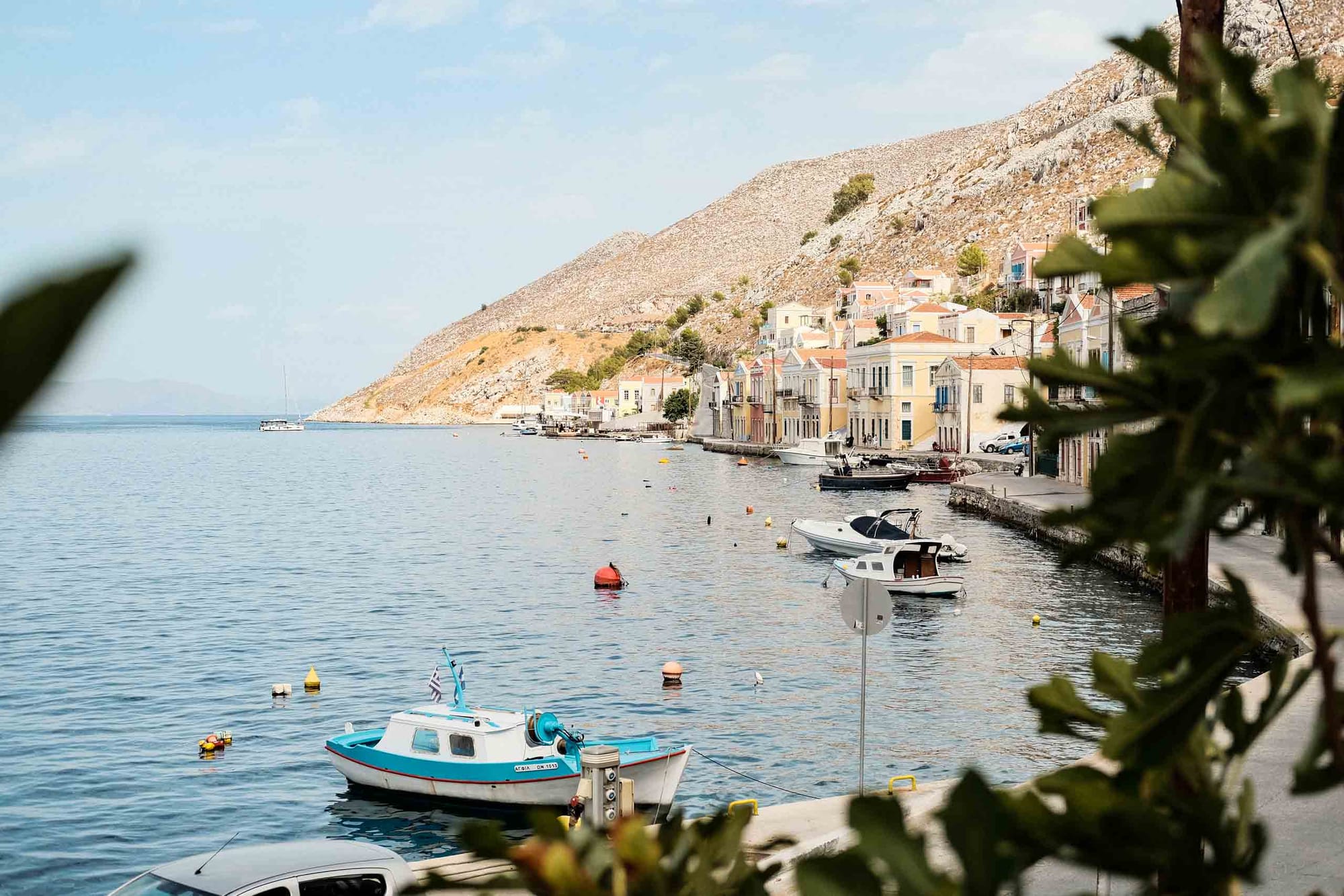 sample image with Fujifilm XF35mm f2 at f3.6 — Symi, Greece — pastel waterfront houses and fishing boats along the harbor
