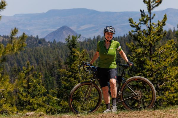 Amy with her bicycle on the crest of the Ochoco mountains